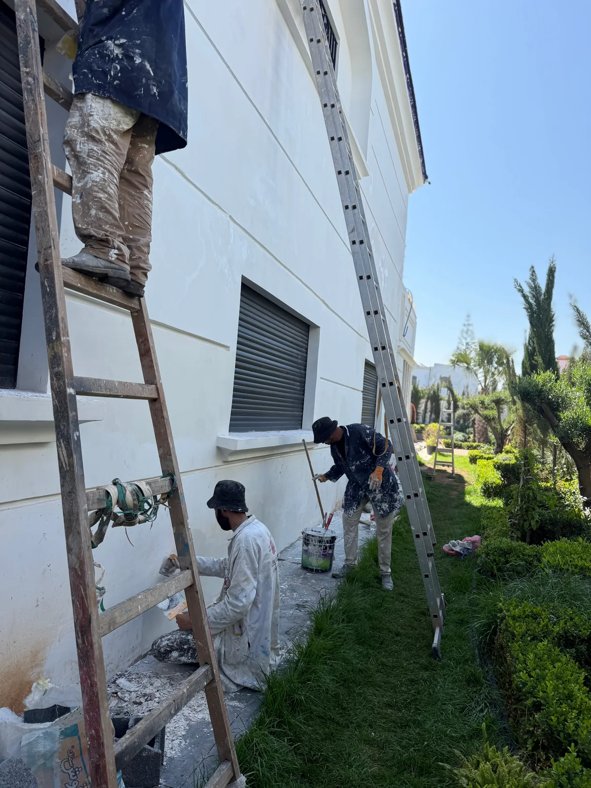 Équipe au travail le long de la façade de la villa d’Aïn Diab à Casablanca